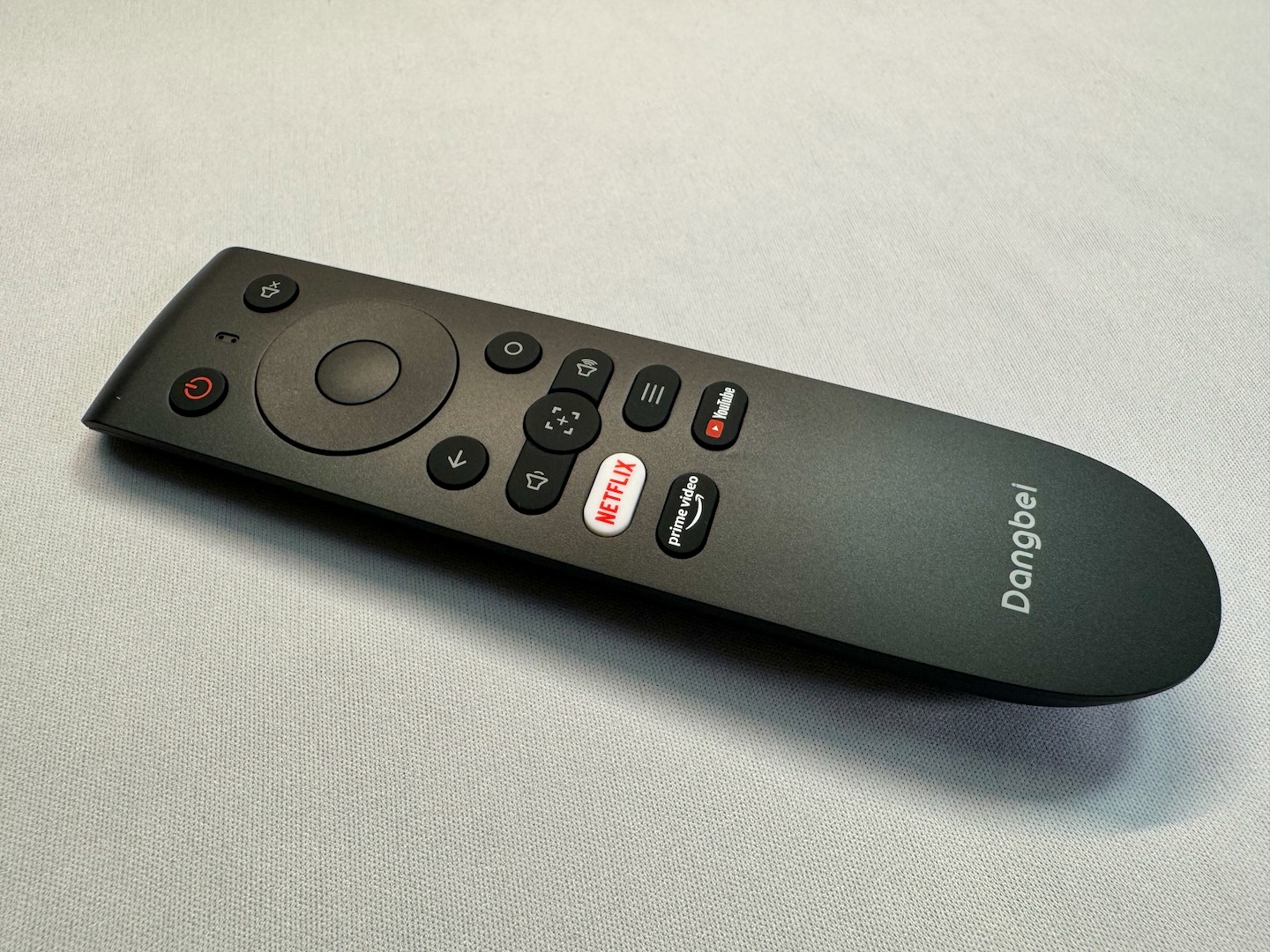 The remote has buttons for Netflix, Amazon Prime Video, and YouTube.